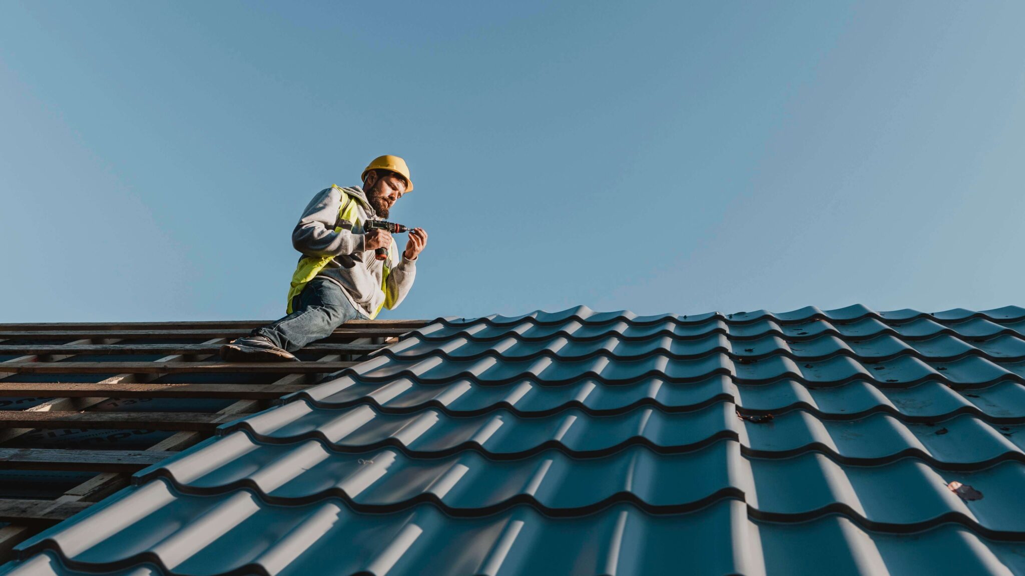 long shot man working roof 1